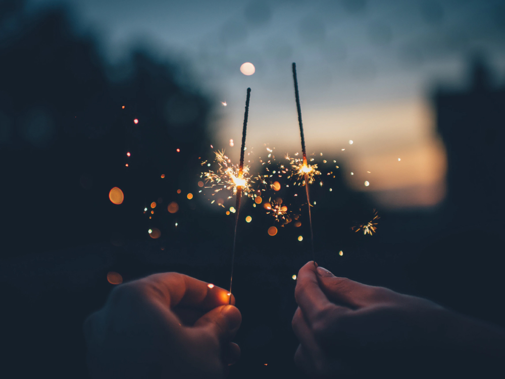 two hands with sparklers