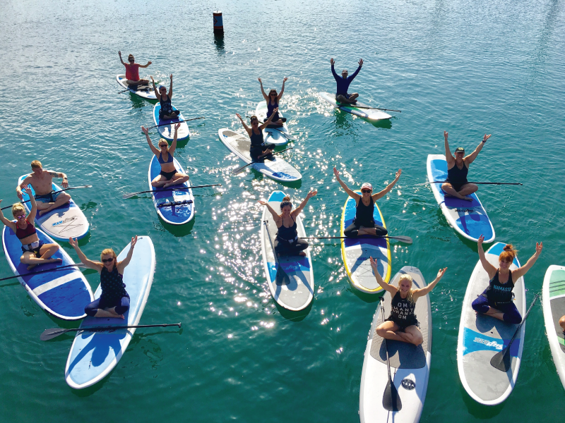 people on paddle boards