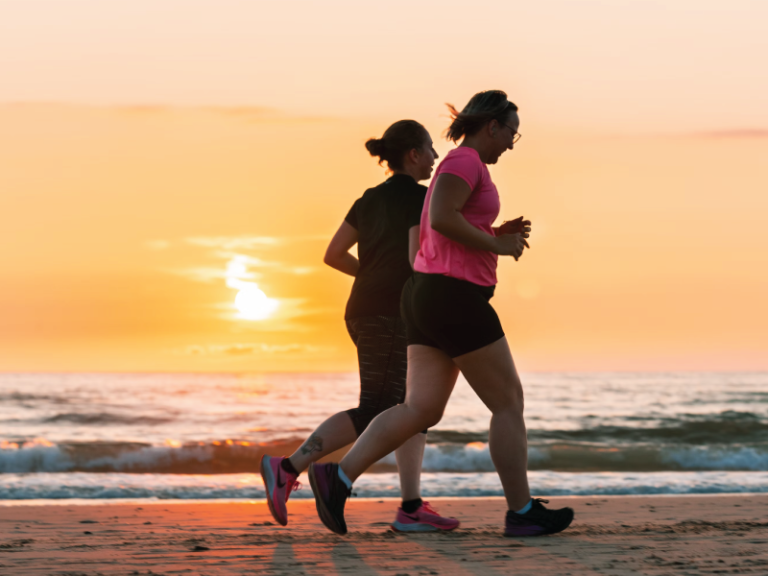 two women running on the beach