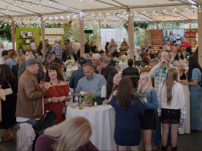 group of people dining under a tent canopy