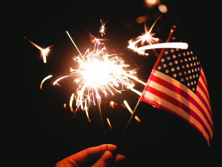 hand holding flag and sprinkler